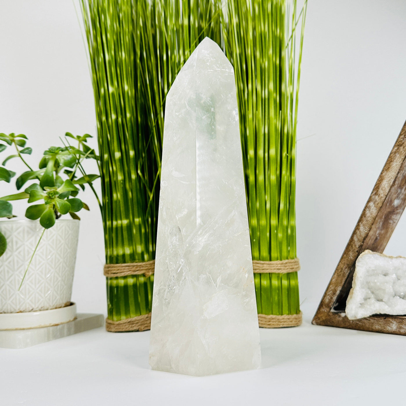 Crystal Quartz Polished Tower with decorations in the background