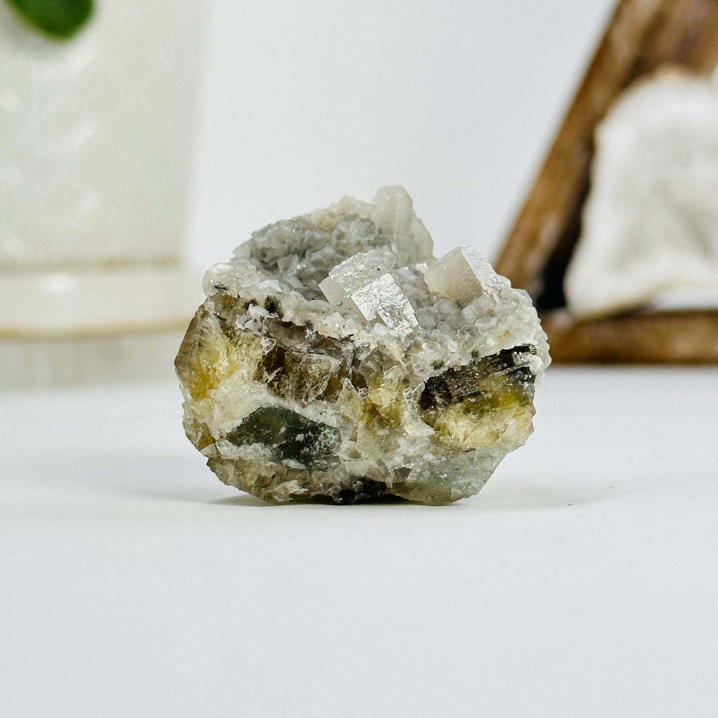 epidote with crystal quartz growth cluster with decorations in the background