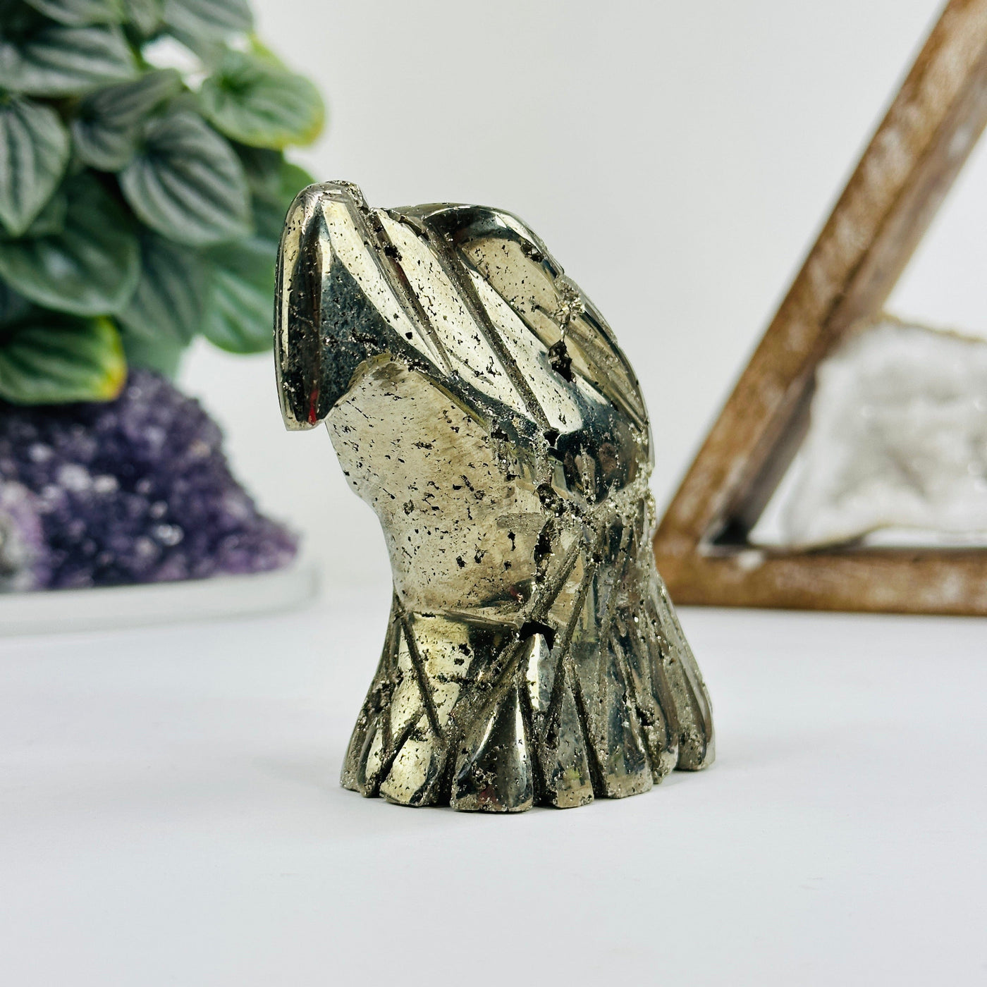 Pyrite eagle head with decorations in the background