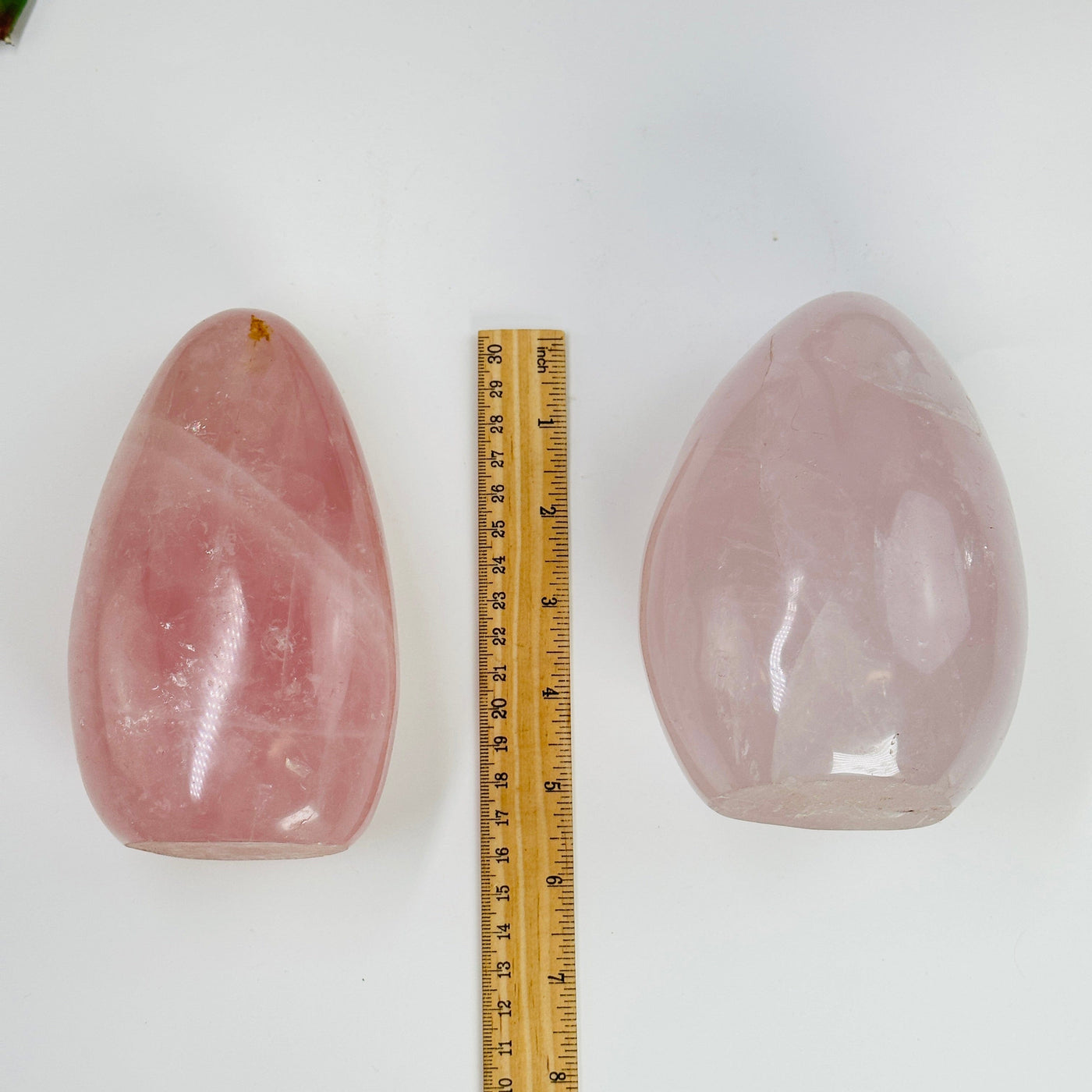 rose quartz cut base next to a ruler for size reference