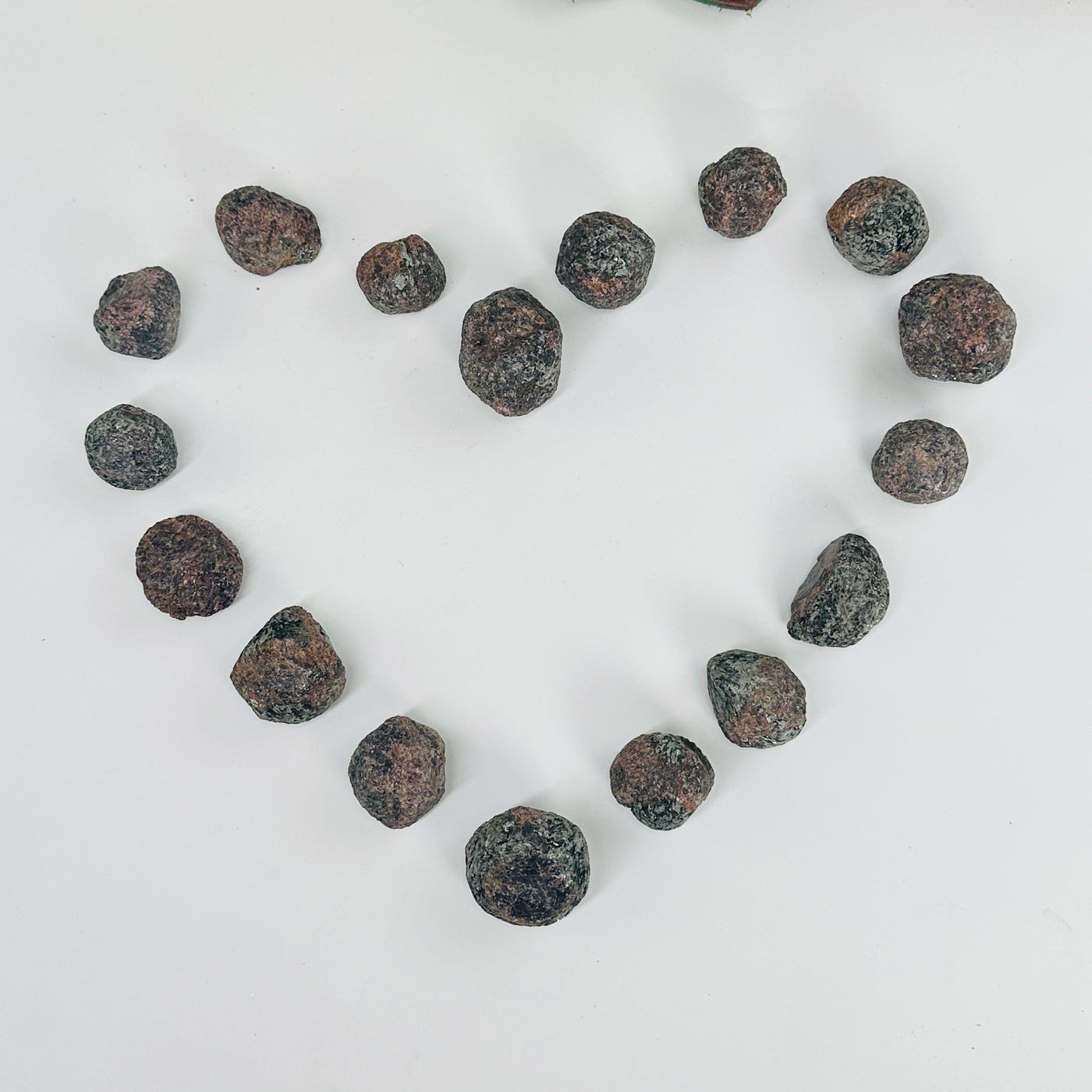 garnet tough stones in a heart shape one white background