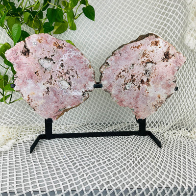 Pink amethyst wings with decorations in the background