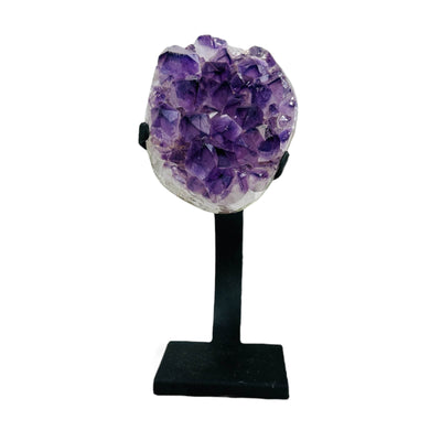 polished amethyst on stand on white background