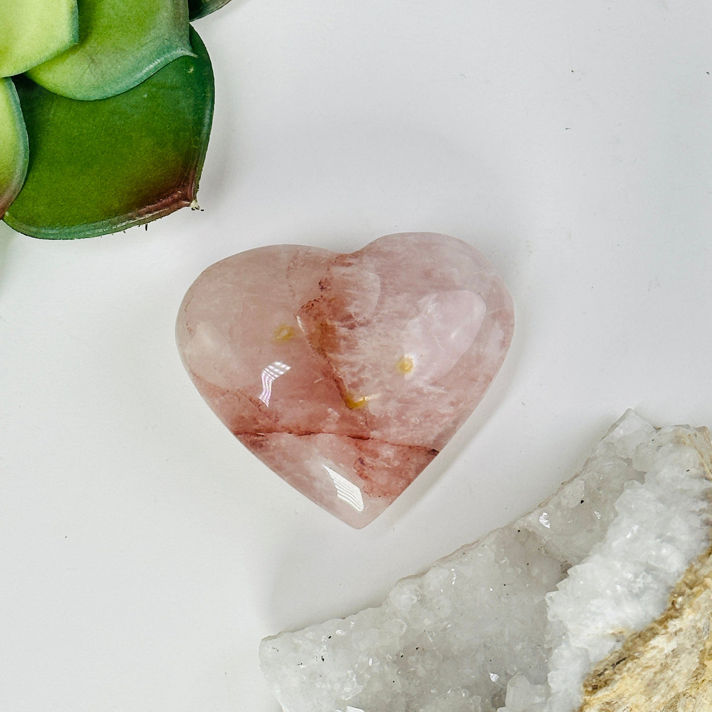 hematoid quartz heart with decorations in the background