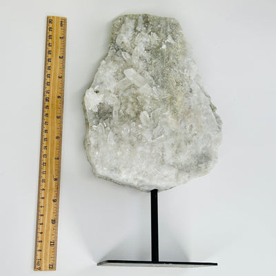 crystal quartz with sugar druzy on metal stand next to a ruler for size reference