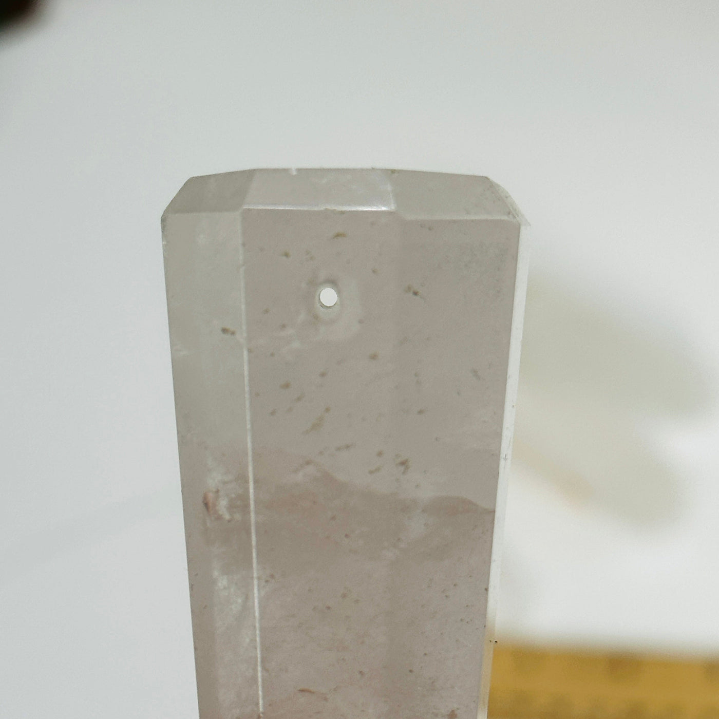 up close shot of hole in crystal quartz obelisk point