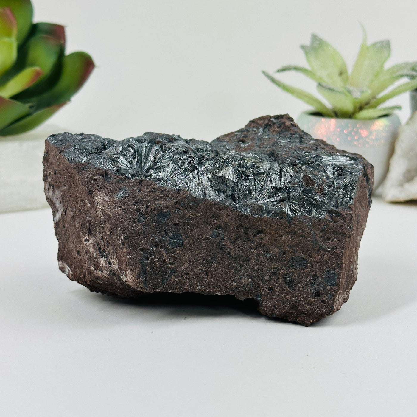 stibnite on matrix formation with decorations in the background