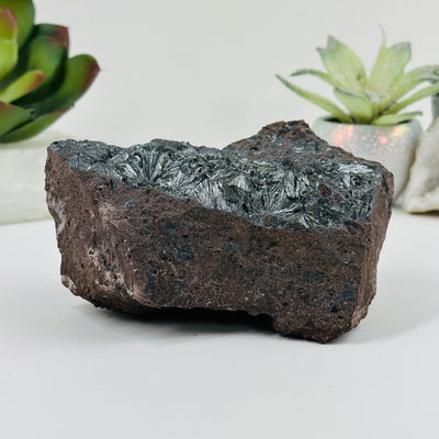 stibnite on matrix formation with decorations in the background