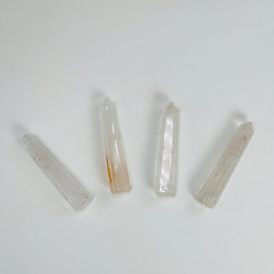 crystal quartz think obelisks drilled on white background