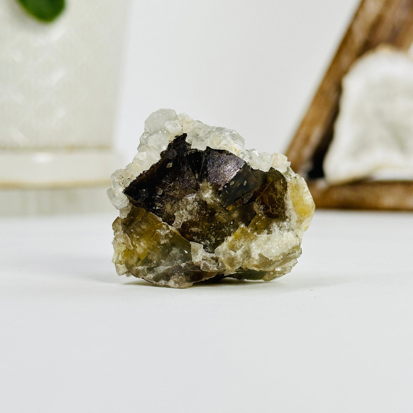 epidote with crystal quartz growth cluster with decorations in the background