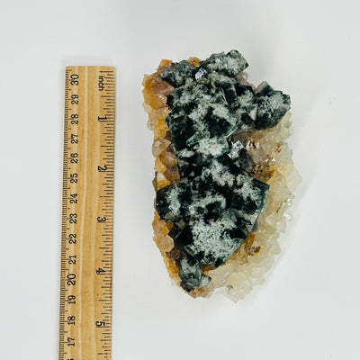 milky way fluorite next to a ruler for size reference