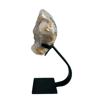 side view of amethyst with stand on white background