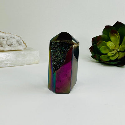variant 2 of rainbow titanium coated agate point with decorations in the background