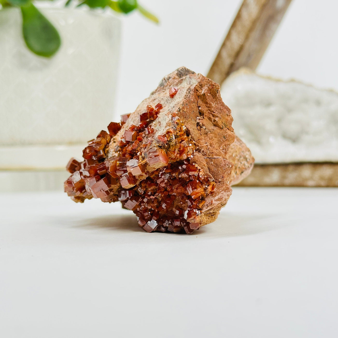 side view of Natural vanadinite formation with decorations in the background