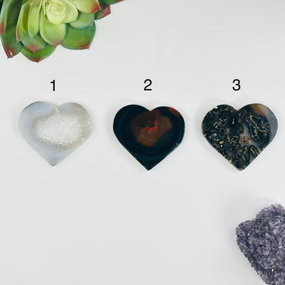 backside of all variants of Natural Agate Heart Slices with decorations on white background