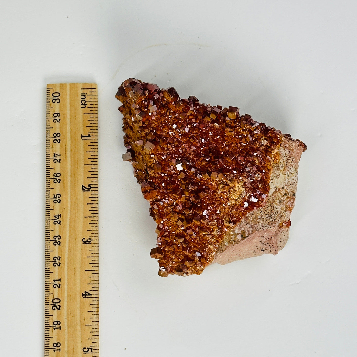 vanadinite next to a ruler for size reference