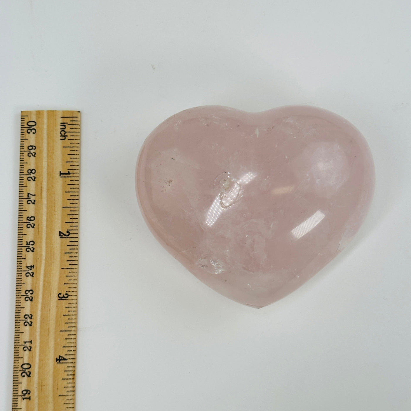 Rose Quart puff heart next to a ruler for size reference