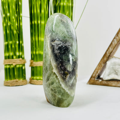 fluorite polished cutbase with decorations in the background
