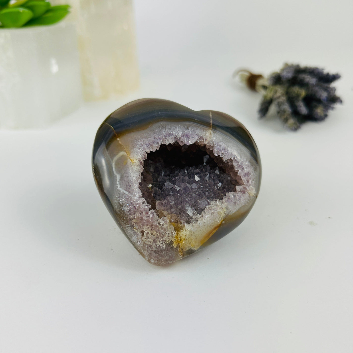 angled shot of agate heart with decorations in the background