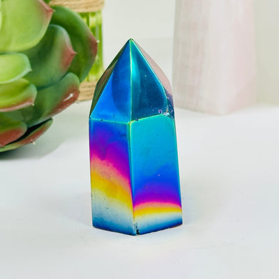 rainbow titanium agate point with decorations in the background
