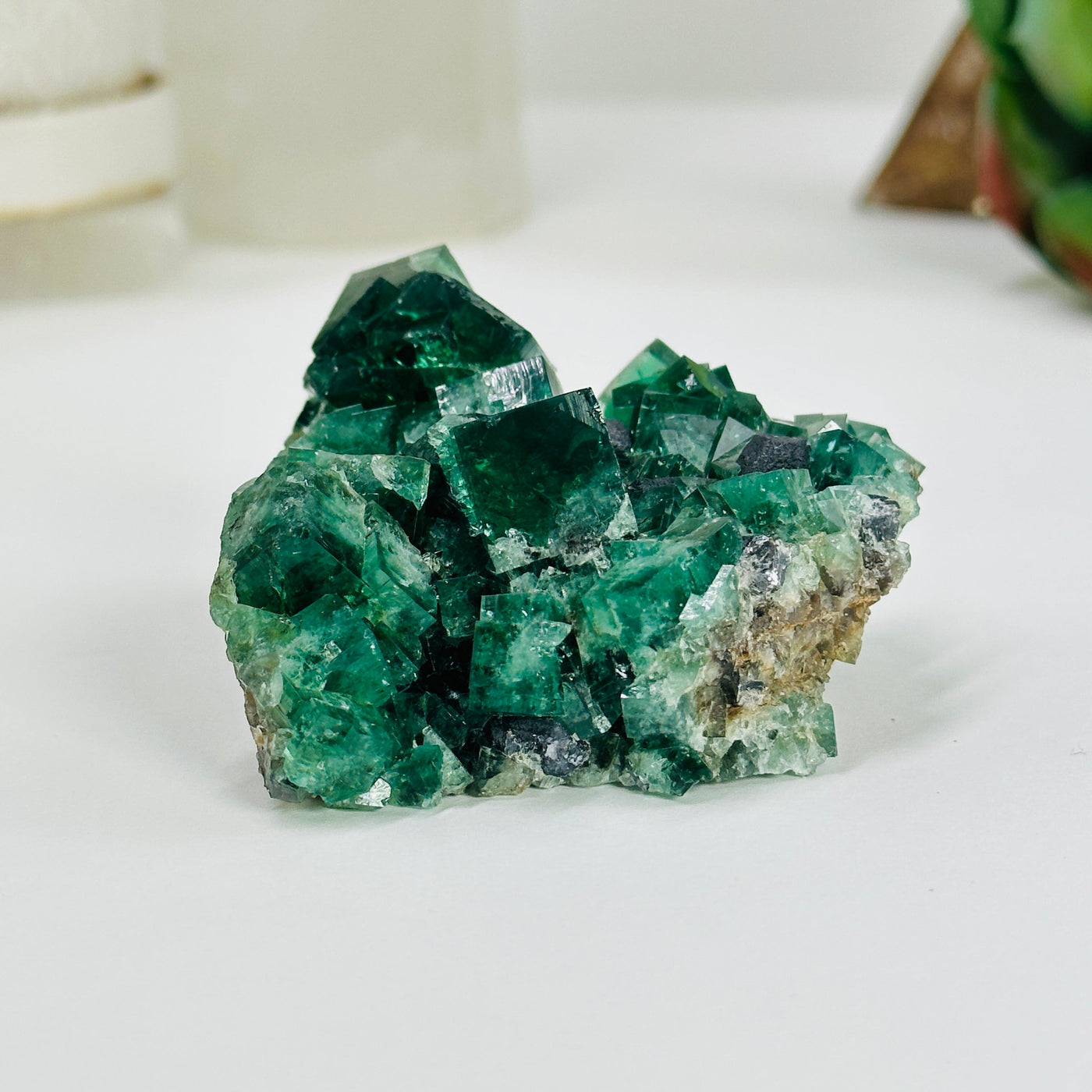 cubic fluorite with decorations in the background