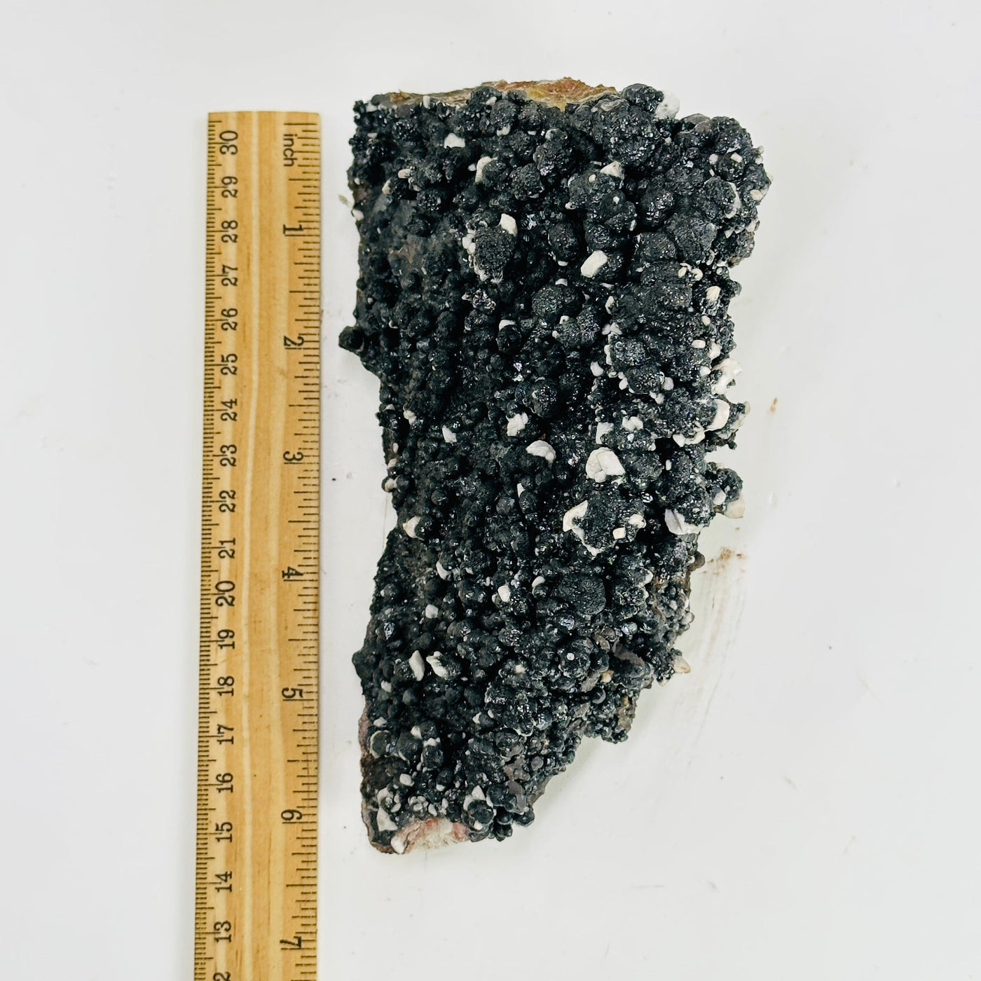 goethite calcite cluster next to a ruler for size reference