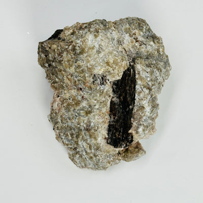 backside of topaz with polylithionite on white background