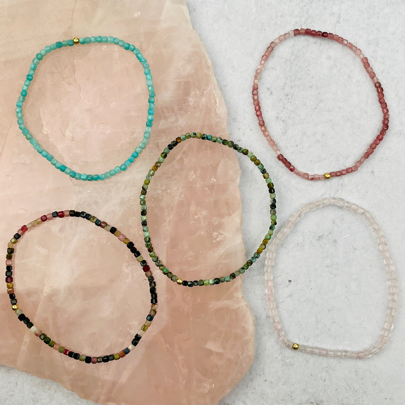 bracelets displayed to show the differences in the gemstone types 