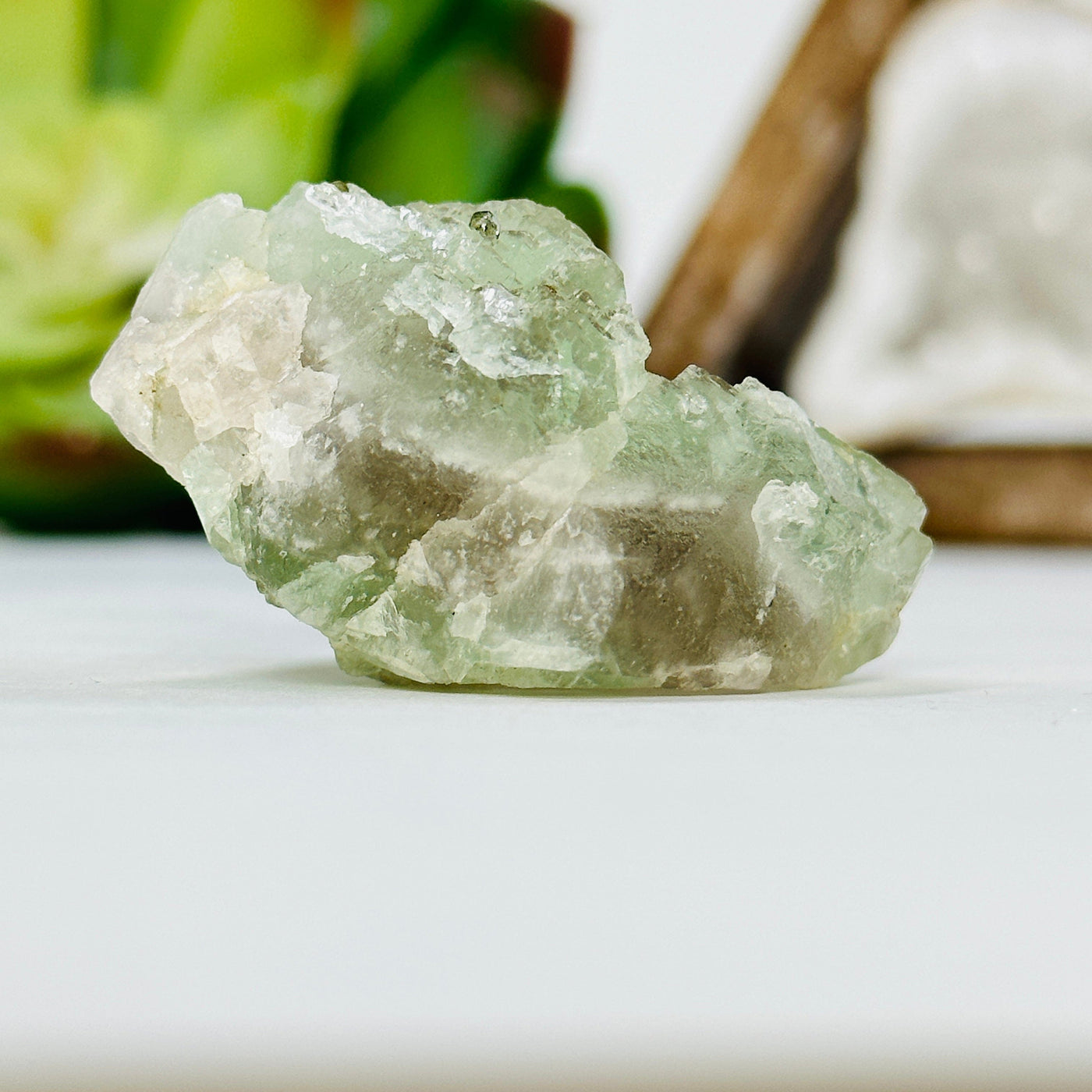 green fluorite with epidote growth with decorations in the background