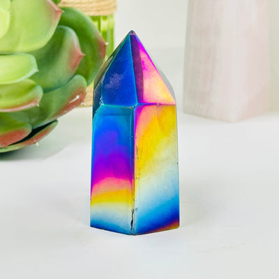 rainbow titanium agate point with decorations in the background
