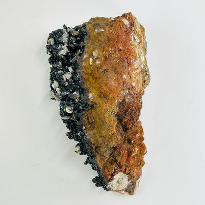backside of goethite calcite cluster on white background