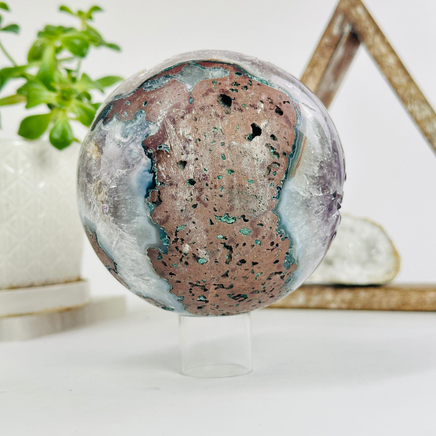 amethyst druzy sphere with decorations in the background