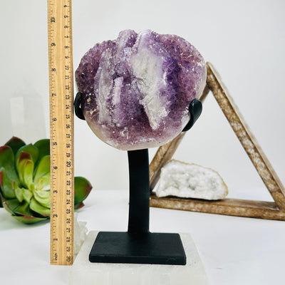 amethyst with stand next to a ruler for size reference