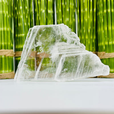 Clear Selenite Slab with decorations in the background