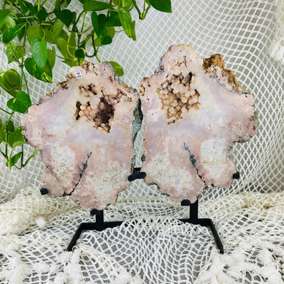 Pink amethyst wings on metal stand with decorations in the background