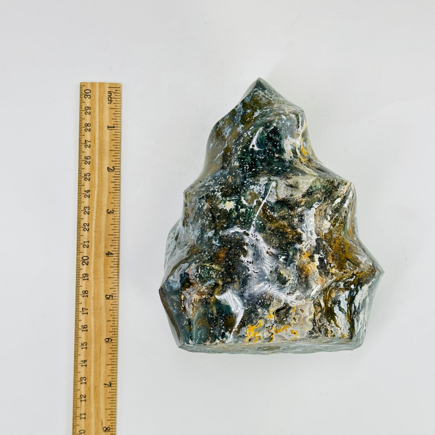 ocean jasper flame tower next to a ruler for size reference