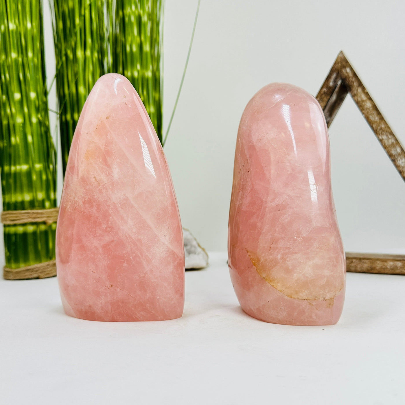 side view of rose quartz polished cutbases with decorations in the background