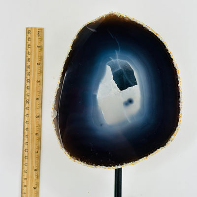 Natural Dark Agate with Druzy Center on Metal Stand next to a ruler for size reference