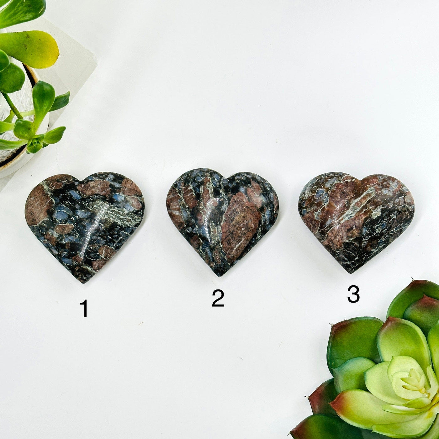 backside of 3 rhyolite hearts with decorations surrounding them