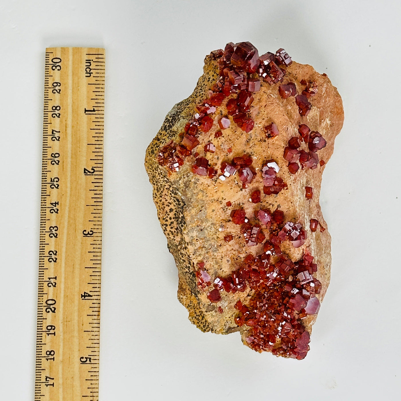 vanadinite next to a ruler for size reference