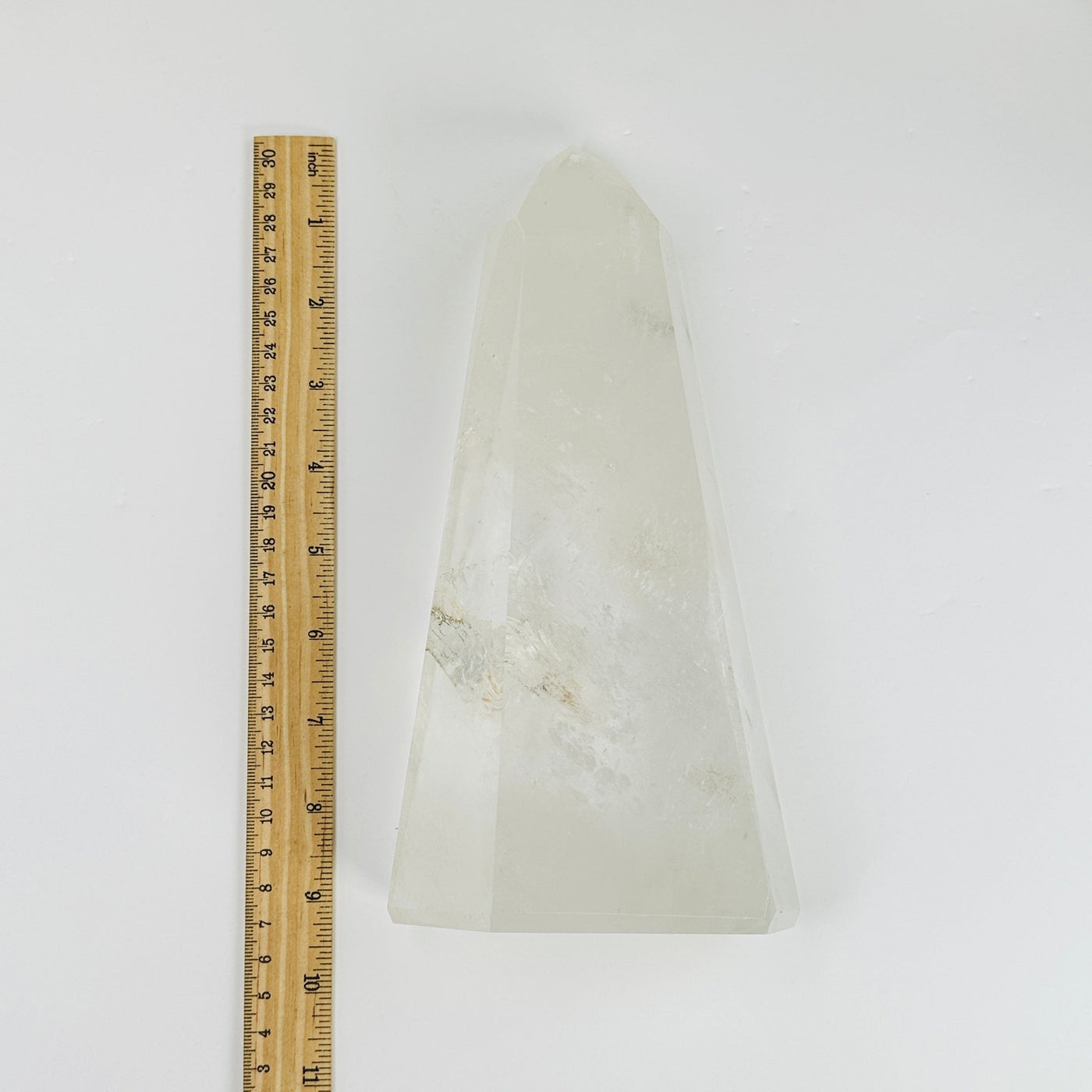 Crystal Quartz polished tower next to a ruler for size reference