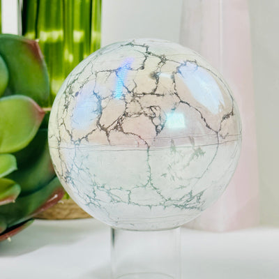 aura howlite sphere with decorations in the background