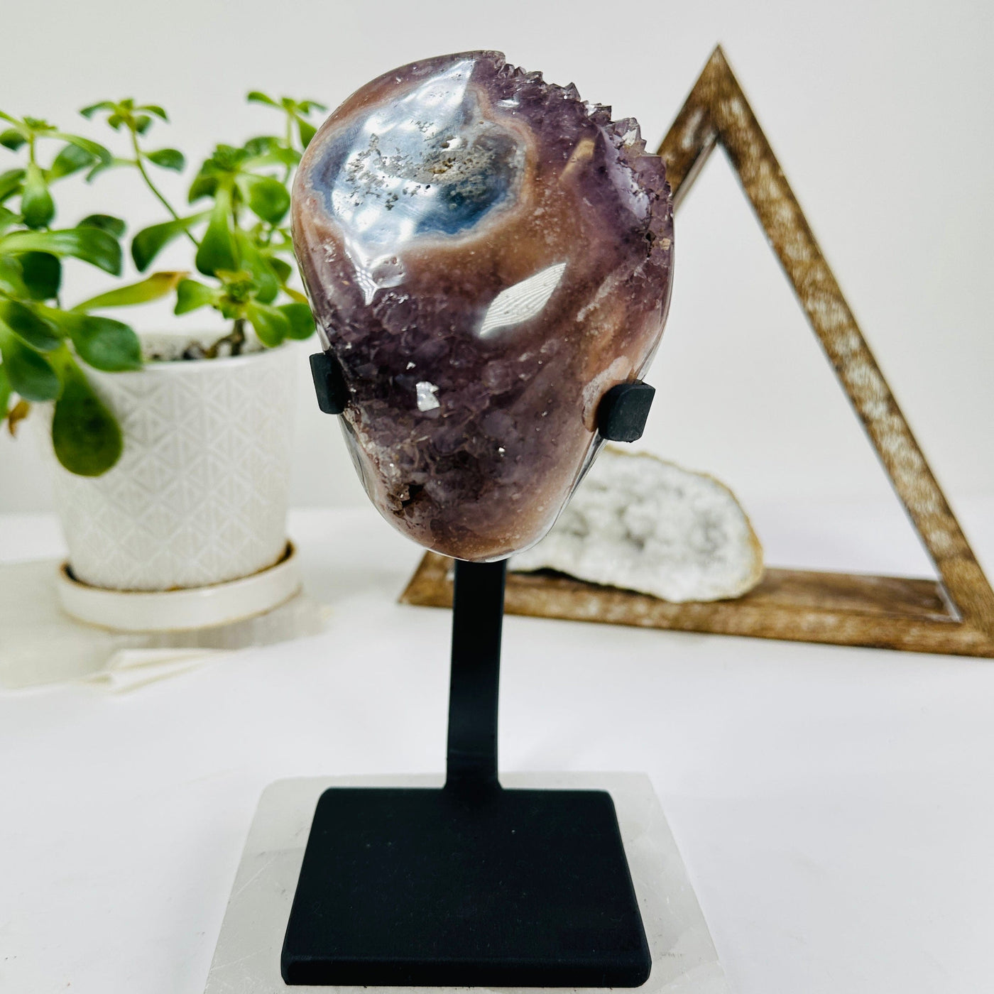 amethyst on metal stand with decorations in the background