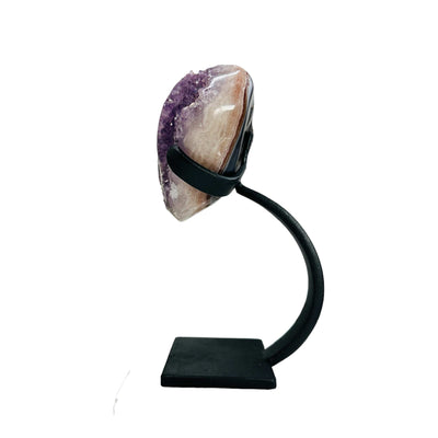 side view of amethyst with stand on white background