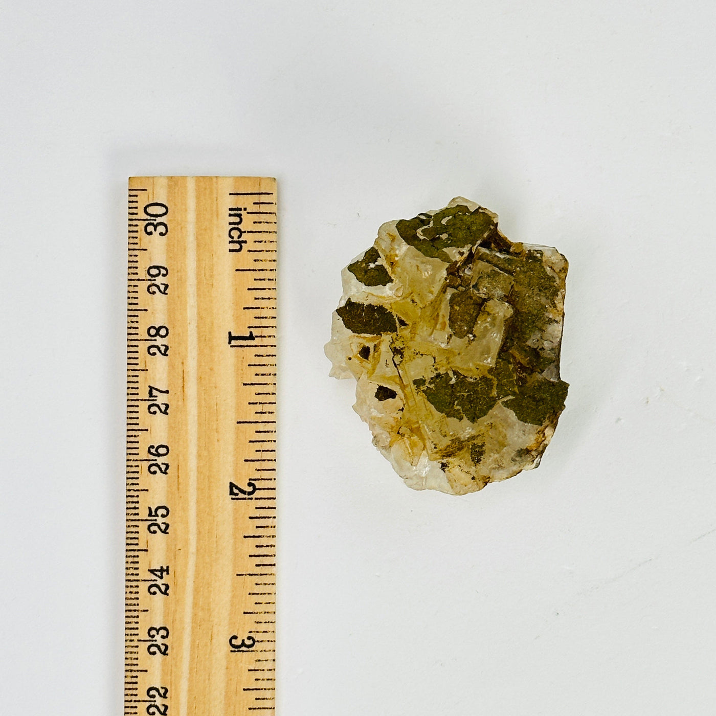 epidote freeform next to a ruler for size reference