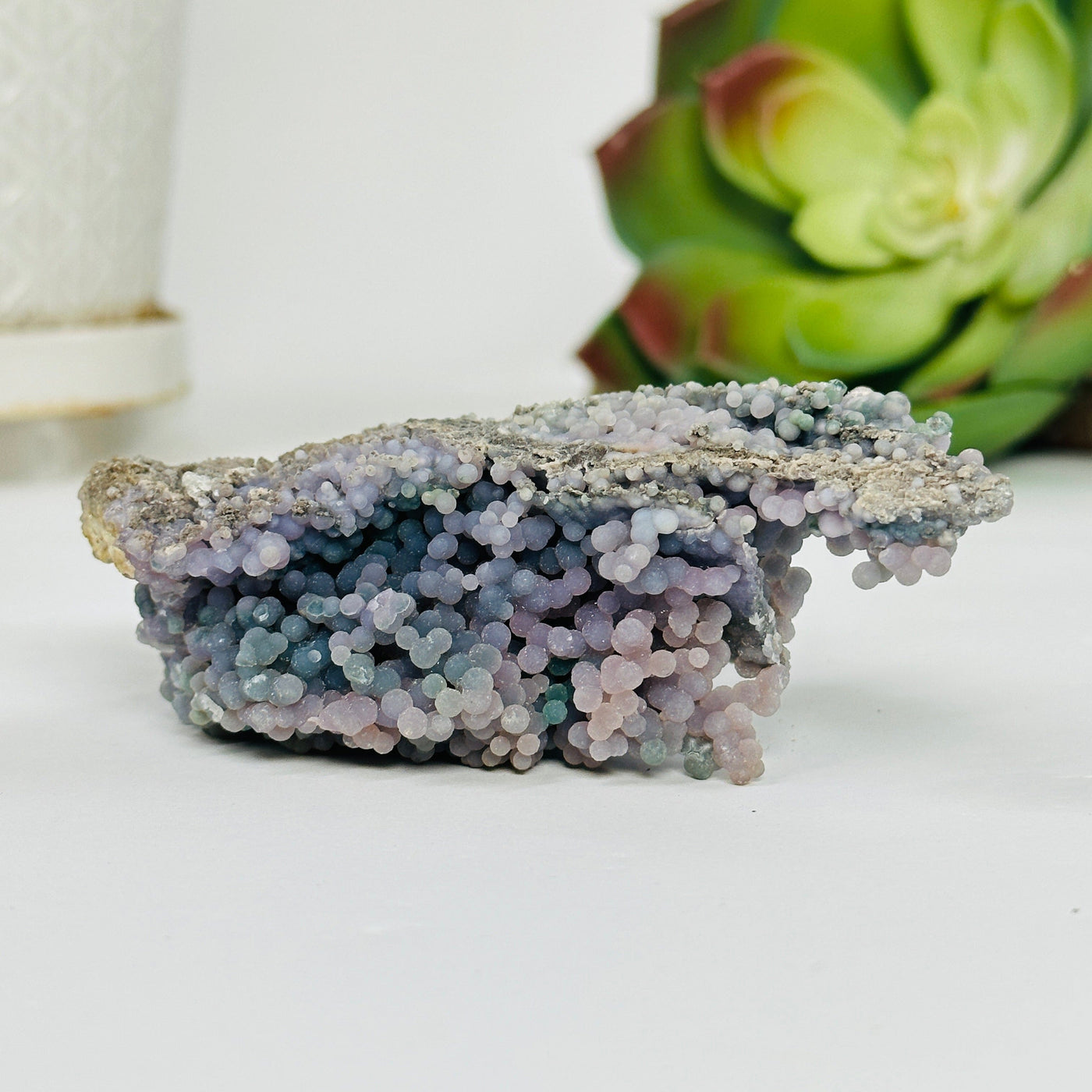 grape agate cluster with decorations in the background
