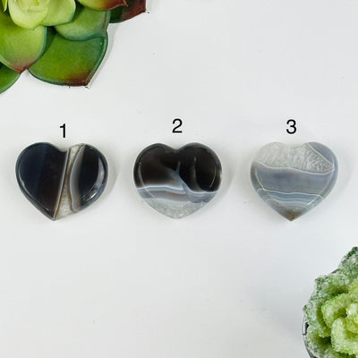 backside of Natural agate heart slices with decorations in the background