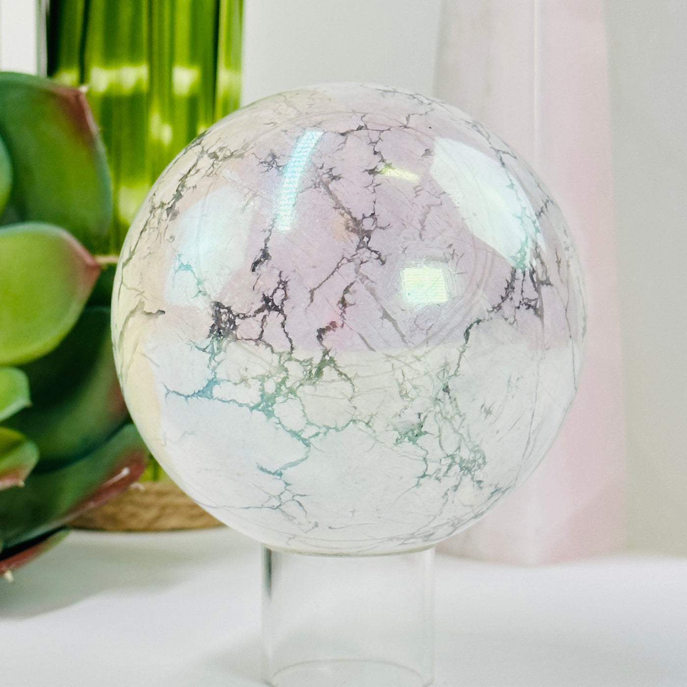 aura howlite sphere with decorations in the background