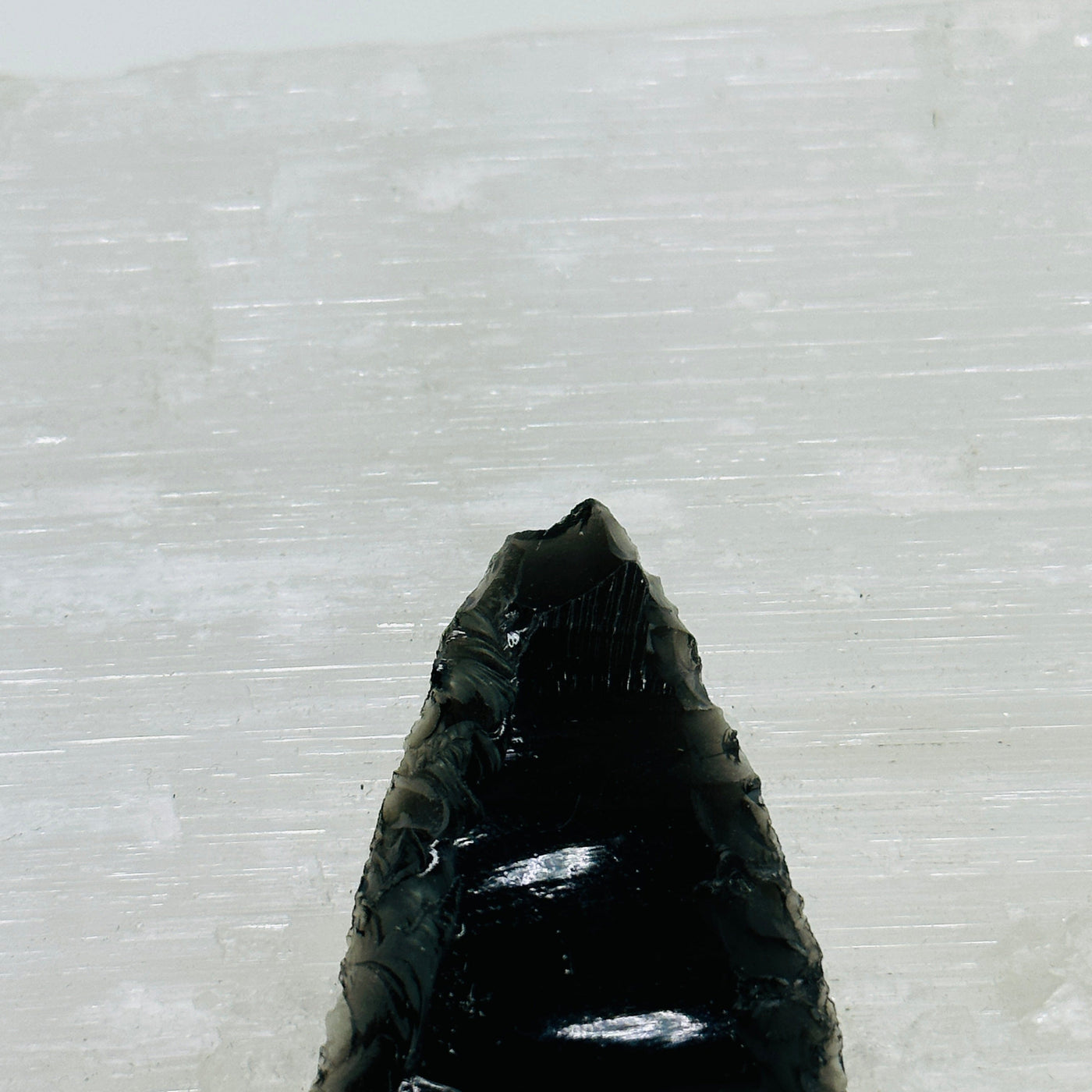 up close shot of chipped obsidian arrowhead tip