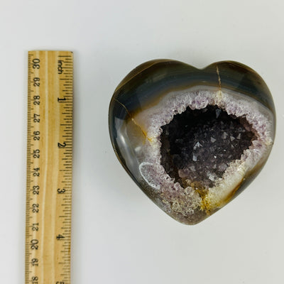agate heart next to a ruler for size reference